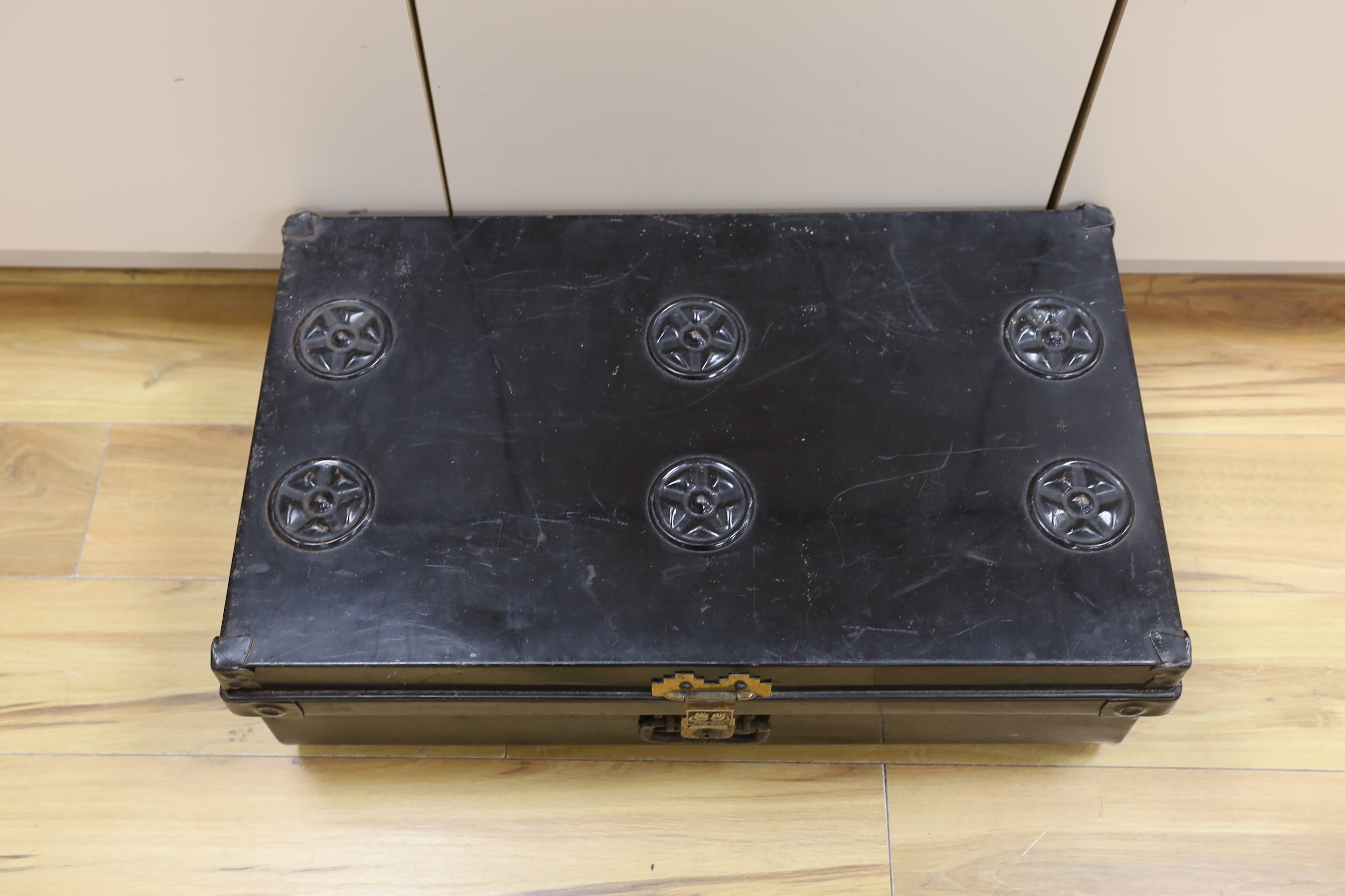 A black lacquered tin trunk, 68cm wide